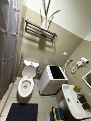 a small bathroom with a toilet and a sink at The Celestia Bay at Shore 2 Residences in Manila