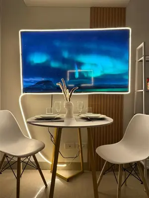 a table with two chairs and a table with wine glasses at The Celestia Bay at Shore 2 Residences in Manila