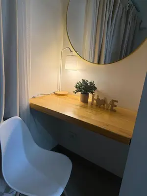 a bathroom with a white chair and a mirror at The Lumora Cove at Shore 2 Residences in Manila
