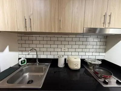 a kitchen with a sink and a counter top at The Lumora Cove at Shore 2 Residences in Manila