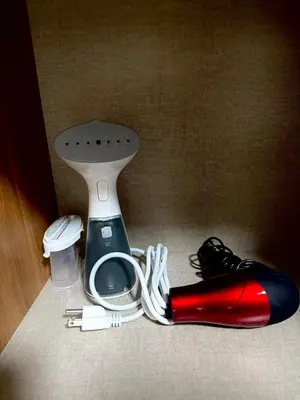 a red and black bottle next to a toilet at The Grand Haven at Shore Residences in Manila