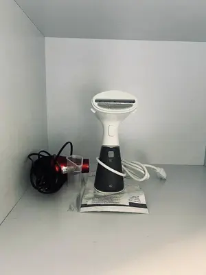 a black and white blender sitting on top of a newspaper at The Sunset Cozy Suite at Shore 1 in Manila