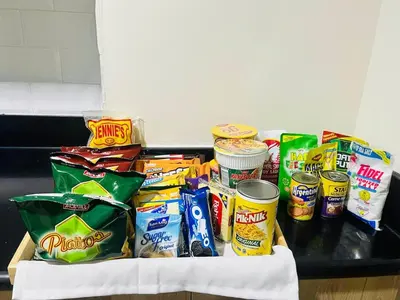 a table topped with different types of food and snacks at The Sunset Cozy Suite at Shore 1 in Manila