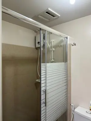 a shower with a glass door in a bathroom at The Cozy Place in Silang