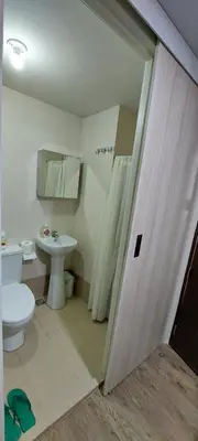 a bathroom with a toilet and a sink at The Cozy Place in Silang