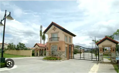 a house with a gate in a driveway at Modern 2 Storey 2BR Home with 2 Parking Space in Manila