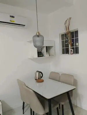 a white table with chairs and a tea kettle on it at Modern 2 Storey 2BR Home with 2 Parking Space in Manila