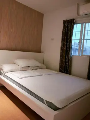 a bedroom with a large bed with a window at Modern 2 Storey 2BR Home with 2 Parking Space in Manila