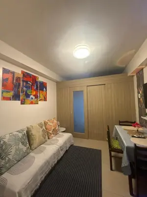 a living room with a couch and a table at Chen Staycation at Shore in Manila