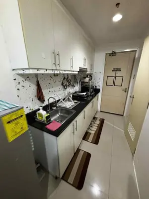 a kitchen with a sink and a counter top at Sea Residence Condotel Tower E&F in Manila