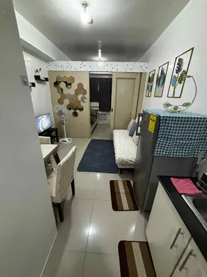 a living room with a couch and a table at Sea Residence Condotel Tower E&F in Manila