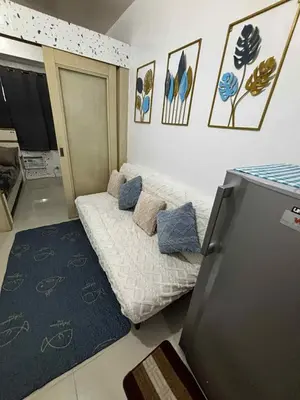 a small room with a bed and a tv at Sea Residence Condotel Tower E&F in Manila