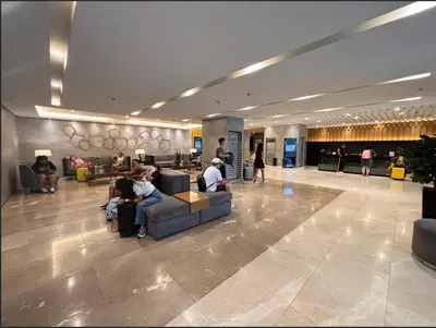 a group of people sitting on couches in a lobby at Vera's Place in Mall of Asia Complex in Manila