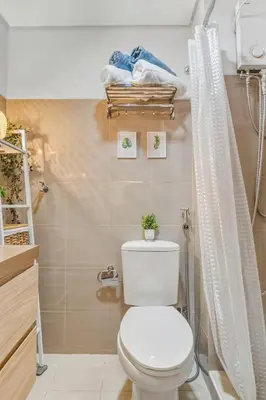 a bathroom with a toilet and a shower at Japandi Aesthetic Corner Unit, Calm & Private, MOA in Manila