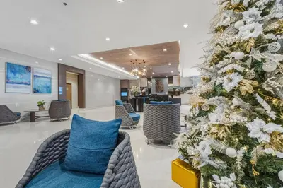 a christmas tree in the lobby of a hotel at Japandi Aesthetic Corner Unit, Calm & Private, MOA in Manila