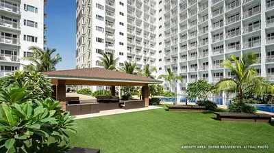 a garden with a gazebo in front of a large building at Japandi Aesthetic Corner Unit, Calm & Private, MOA in Manila