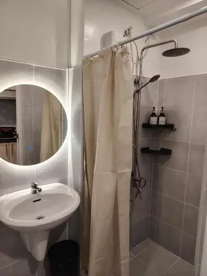 a bathroom with a sink and a shower at Ana's Homestay at Sea Residences in Manila
