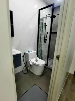 a bathroom with a toilet and a sink and a shower at Modern 3BR Cozy Homestay Antipolo in Antipolo