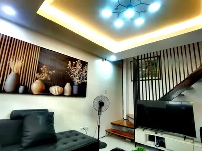 a living room with a couch and a flat screen tv at Modern 3BR Cozy Homestay Antipolo in Antipolo