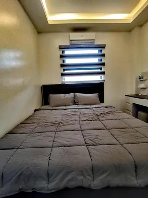 a bedroom with a large bed with a window at Modern 3BR Cozy Homestay Antipolo in Antipolo
