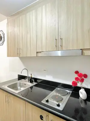 a kitchen with a sink and a counter top at E&C Rentals in Manila