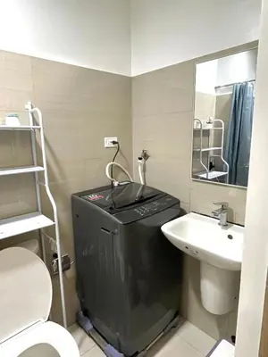 a small bathroom with a toilet and a sink at E&C Rentals in Manila