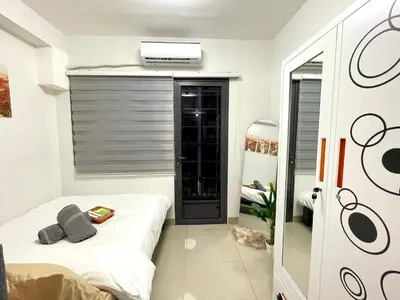 a small bedroom with a bed and a window at E&C Rentals in Manila