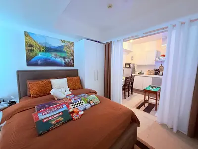 a bedroom with a bed with books and toys on it at Casa Maria urban resort in Manila