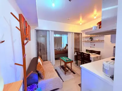 a kitchen and living room with a couch and a table at Casa Maria urban resort in Manila