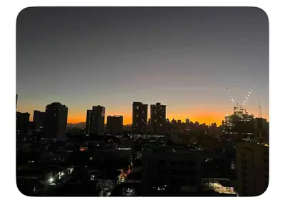 a view of a city skyline at sunset at Casa Maria urban resort in Manila
