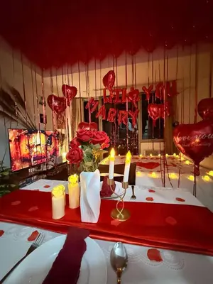 a table with candles and flowers on a table with red decorations at Casa Maria urban resort in Manila