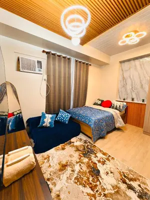 a living room with two beds and a couch at The Verdin Sweet at Maple Grove Gen Tri Cavite in General Trias