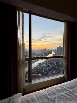 a bedroom window with a view of a city at Novotel at Acqua, The Hotel Residences by RM in Manila