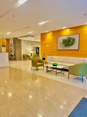a lobby with a couch and a table and chairs at Golden Maison de Luxe in Manila