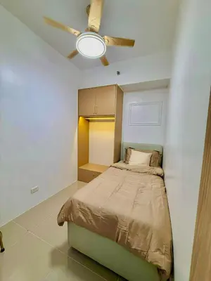a bedroom with a bed and a ceiling fan at Golden Maison de Luxe in Manila
