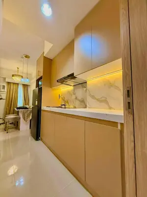 a kitchen with a sink and a refrigerator at Golden Maison de Luxe in Manila