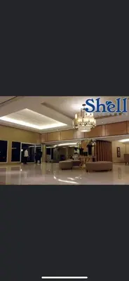 a large lobby with a shilla sign in a building at Maggielyn Jacob Place in Manila