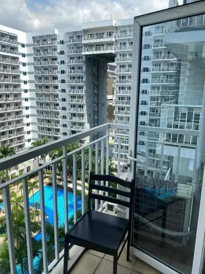 a balcony with a chair and a view of some buildings at Maggielyn Jacob Place in Manila