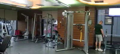 a man standing in a gym with several machines at Modern Cozy Studio in Makati City with Free Pool, Sauna and Gym in Manila