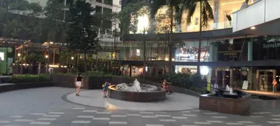 a fountain in the middle of a courtyard in a building at Modern Cozy Studio in Makati City with Free Pool, Sauna and Gym in Manila