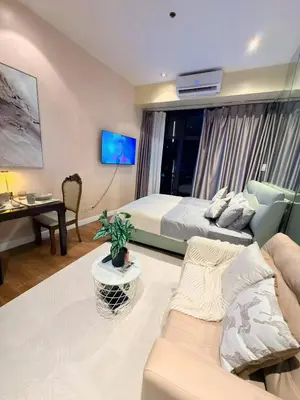 a living room with a bed and a couch at 61F City View at Knightsbridge Makati in Manila