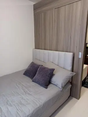 a bed with two pillows on it in a room at Garcia's Unit02, SMDC Fame Residences in Manila