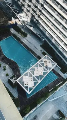 an overhead view of a building with a pool of water at Garcia's Unit02, SMDC Fame Residences in Manila
