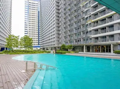 an empty swimming pool in front of a building at Garcia's Unit02, SMDC Fame Residences in Manila