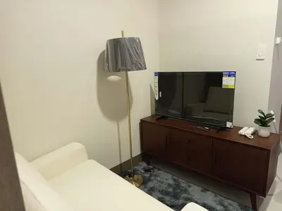a living room with a couch and a tv at Garcia's Unit02, SMDC Fame Residences in Manila
