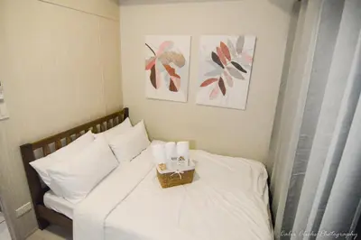 a bedroom with a bed with a basket on it at The Soft Stay 1BR SM Jazz Makati in Manila
