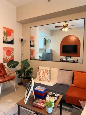 a living room with a couch and a table at The Soft Stay 1BR SM Jazz Makati in Manila