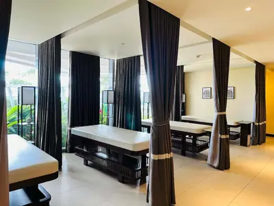 a room with two beds and a large window at Functional and Convenient stay in Eastwood City in Manila