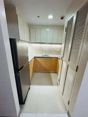 a small kitchen with a sink and a refrigerator at Functional and Convenient stay in Eastwood City in Manila