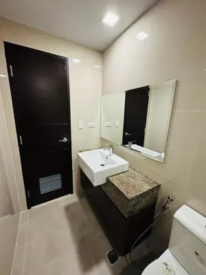 a bathroom with a sink and a mirror at Functional and Convenient stay in Eastwood City in Manila